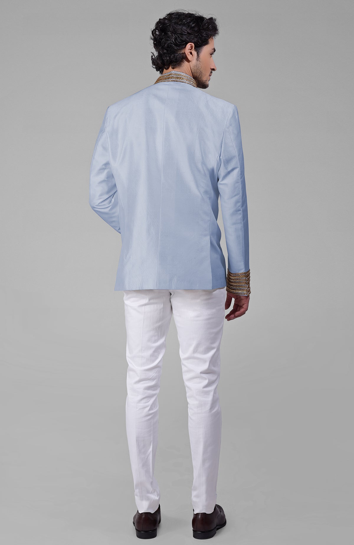 Dusty blue silk bandhgala jacket with gold zardozi embroidery and golden buttons paired with white pants