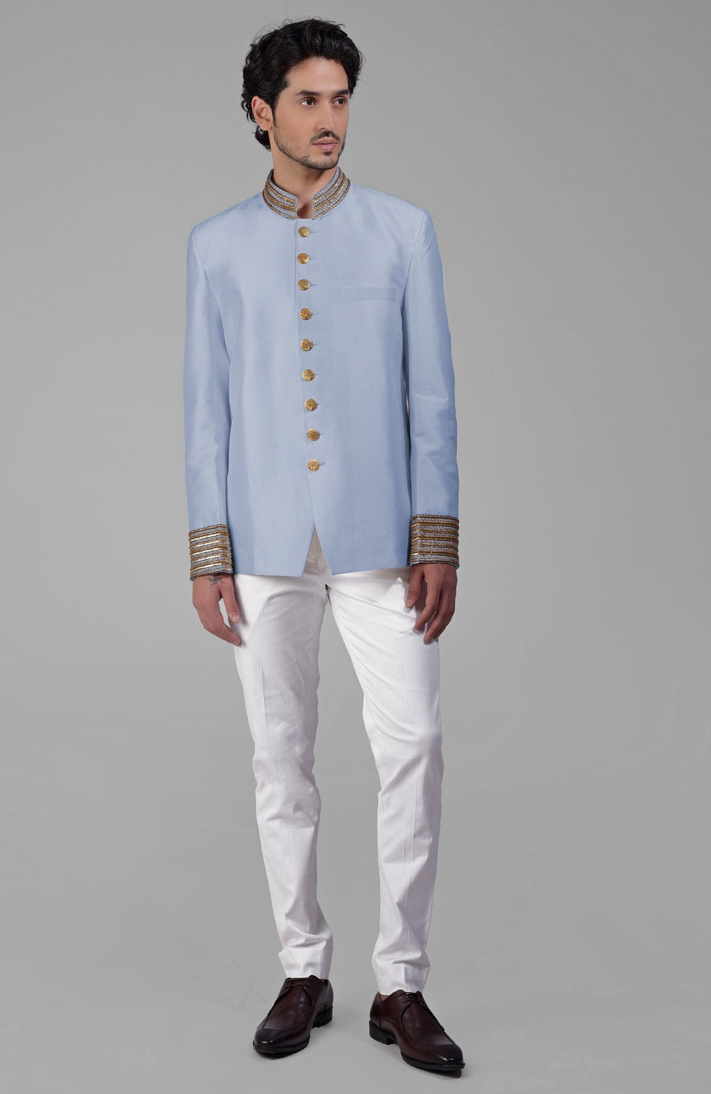 Dusty blue silk bandhgala jacket with gold zardozi embroidery and golden buttons paired with white pants