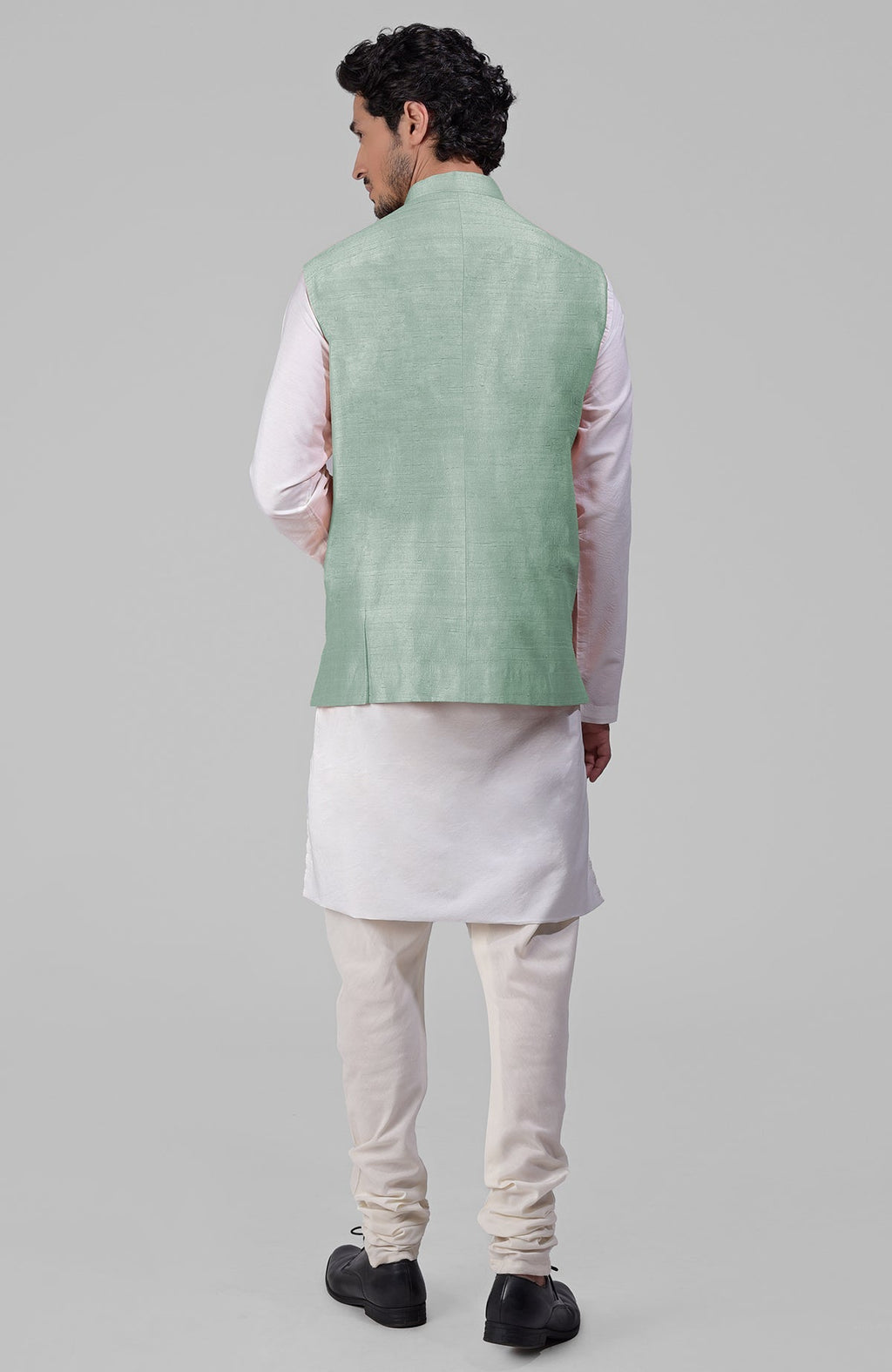 Gossamer green pure raw silk waistcoat bandi jacket with gold peacock emblem buttons.