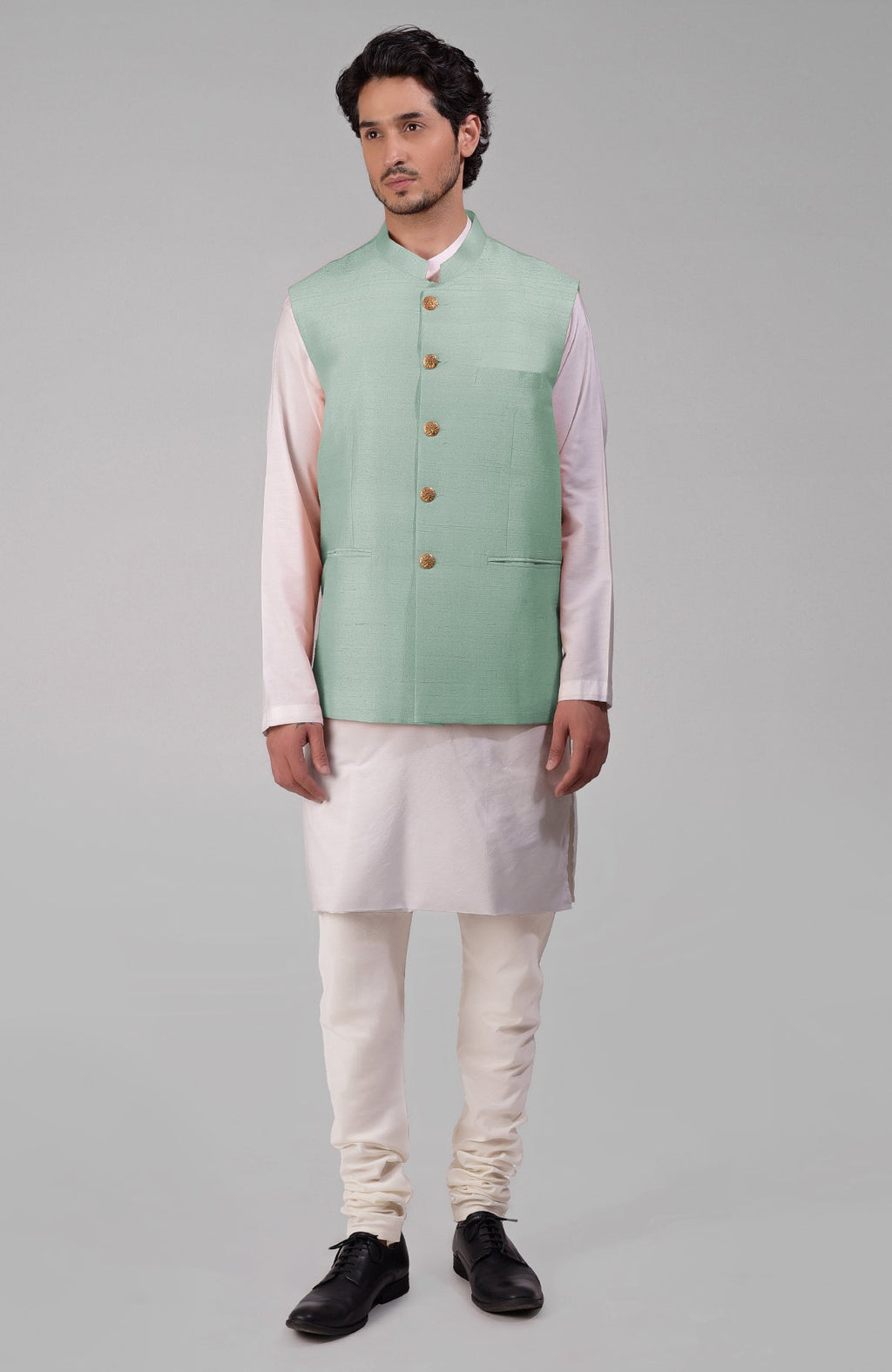 Gossamer green pure raw silk waistcoat bandi jacket with gold peacock button closure.