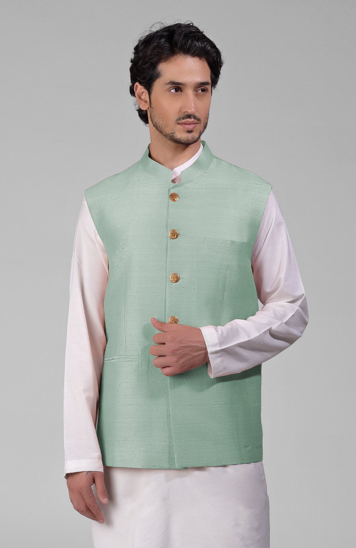 Gossamer green pure raw silk waistcoat bandi jacket with gold peacock button closure.