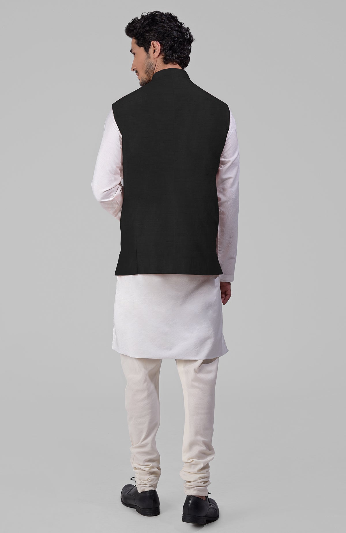 Black pure raw silk waistcoat bandi jacket with gold peacock emblem buttons and clean lines