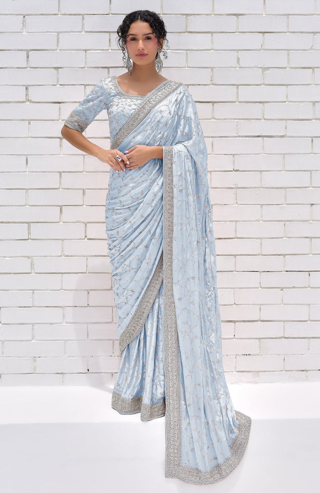 A woman models a powder blue pure silk saree with silver zardozi embroidery.