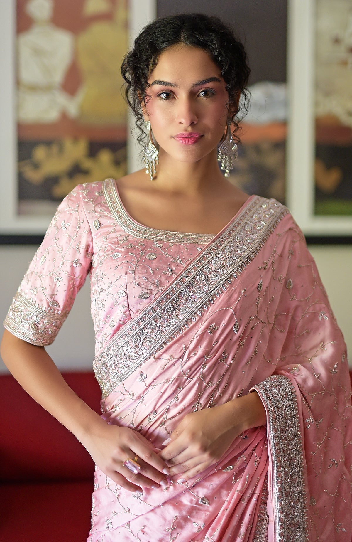 A woman models a pink pure silk saree with silver zardozi hand embroidery.