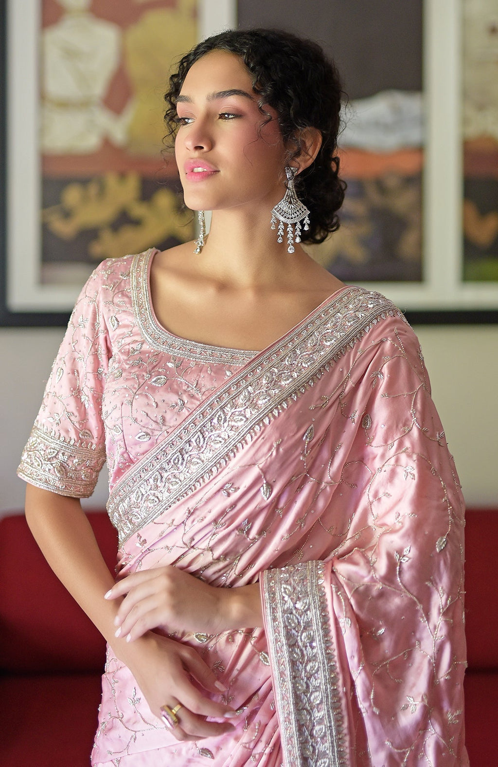 A woman models a pink pure silk saree with silver zardozi hand embroidery.