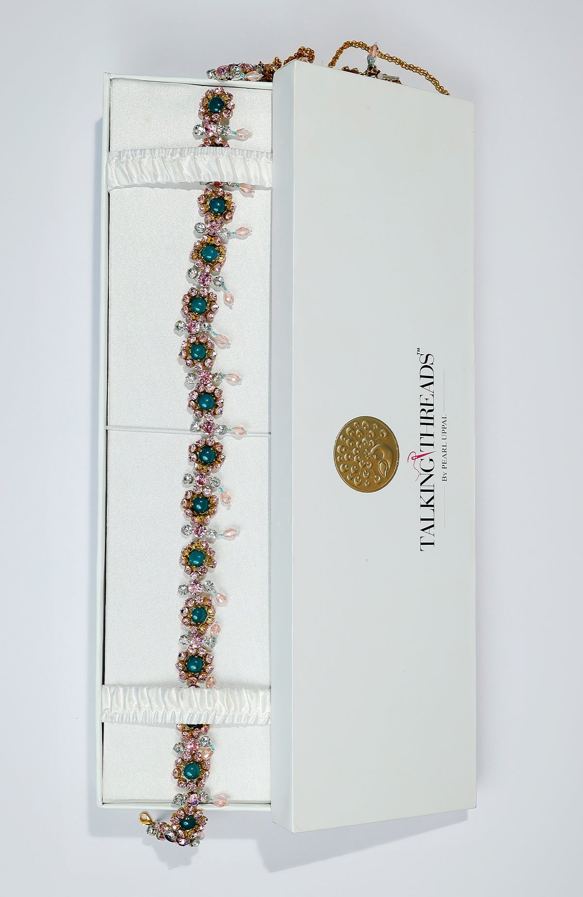 Pink belt adorned with green and pink crystals and golden dangling stones