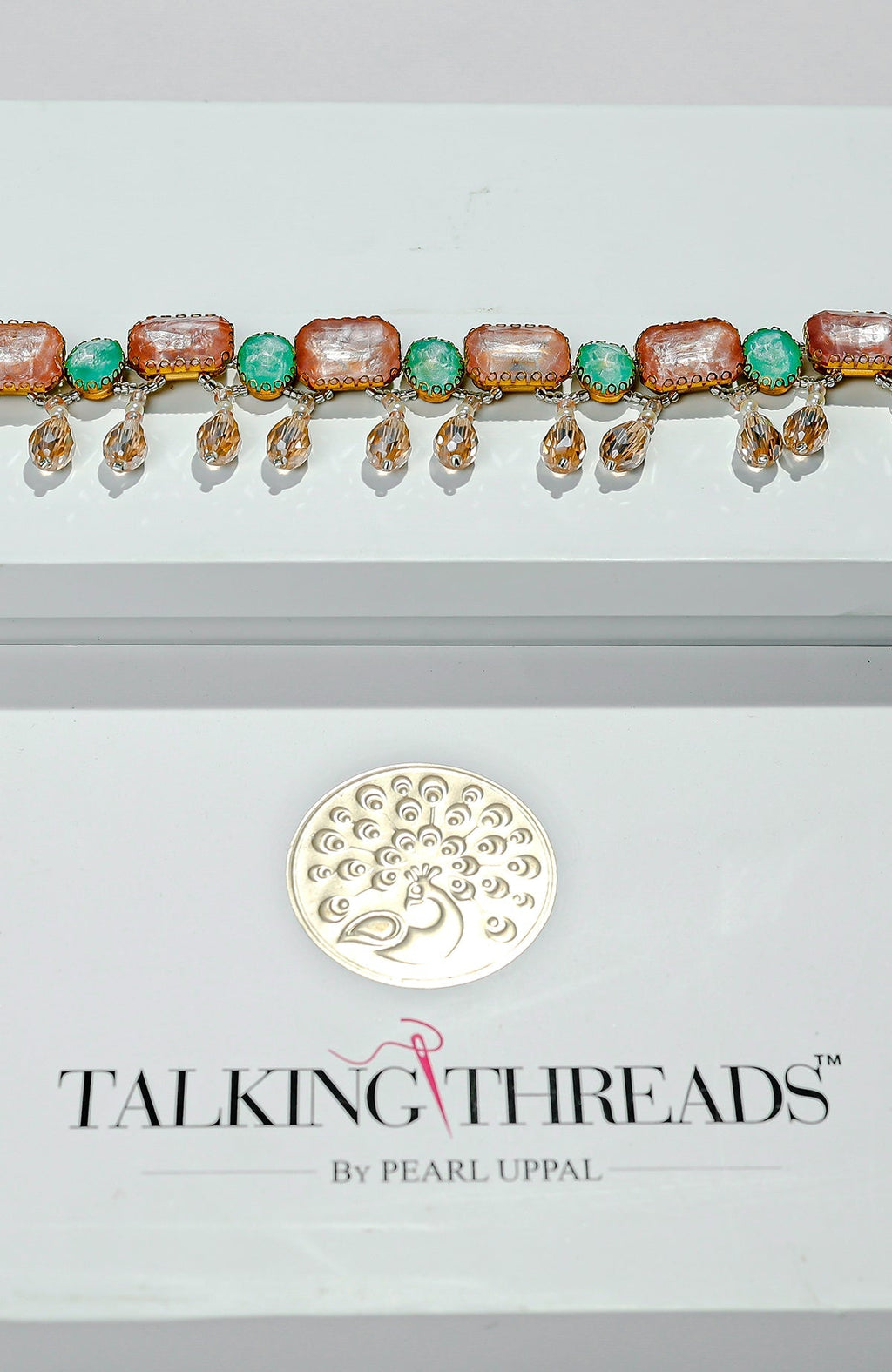 Pink and green jeweled crystal belt with golden dangling stones.