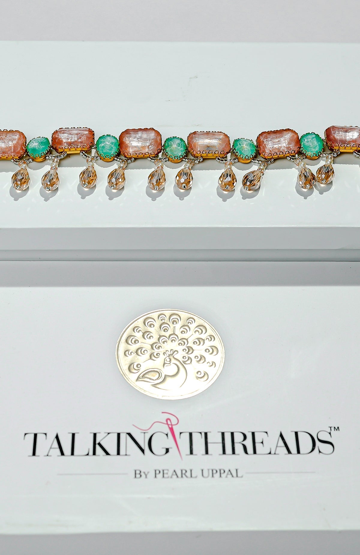 Pink and green jeweled crystal belt with golden dangling stones.