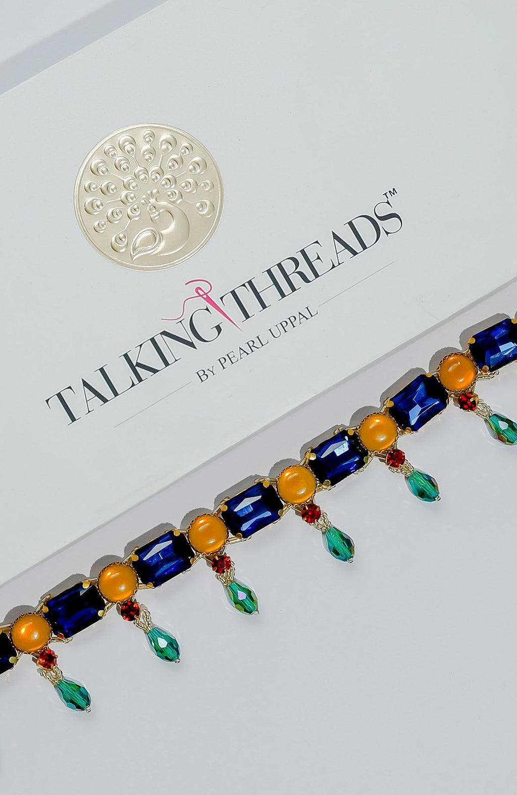 A multi-colored crystal belt with blue, yellow, red, and green stones.