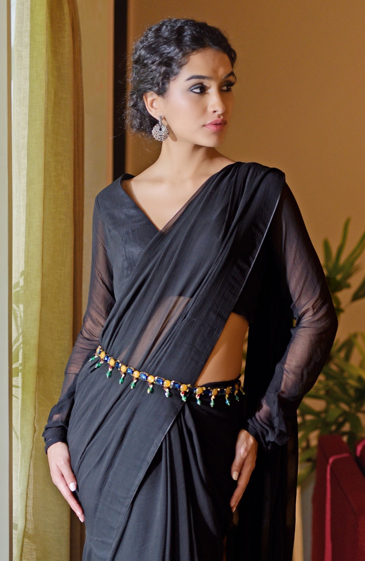 Black chiffon saree with a blue jeweled crystal belt.