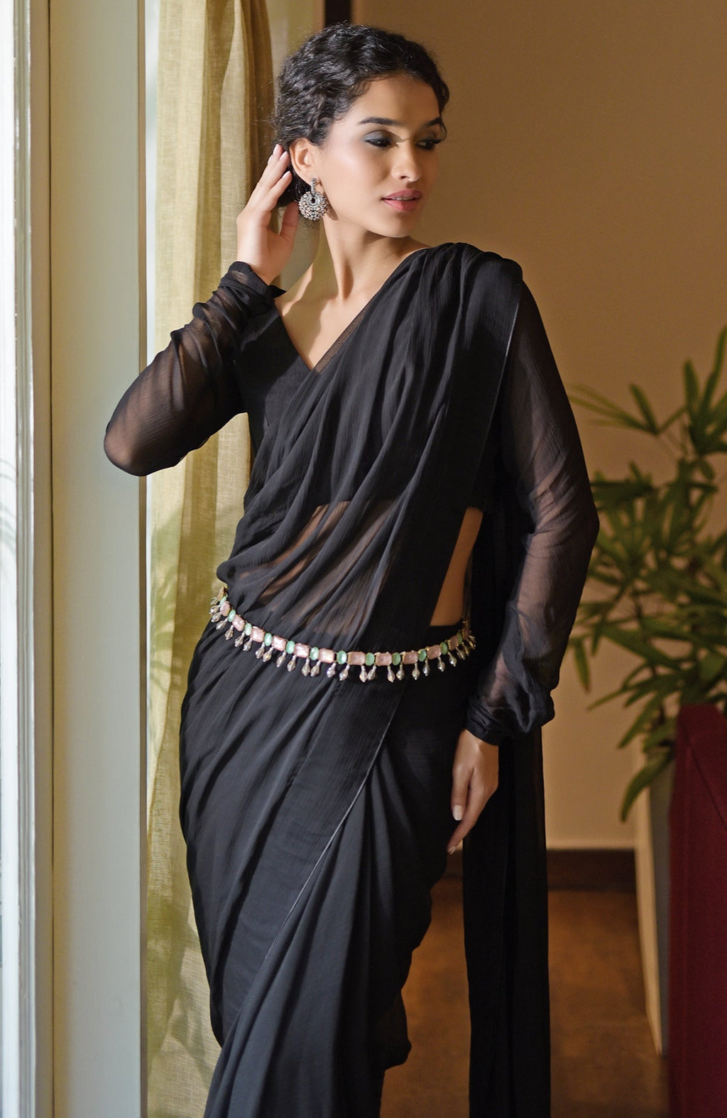 Classic Black Chiffon Saree with a V-neck blouse and sheer sleeves.