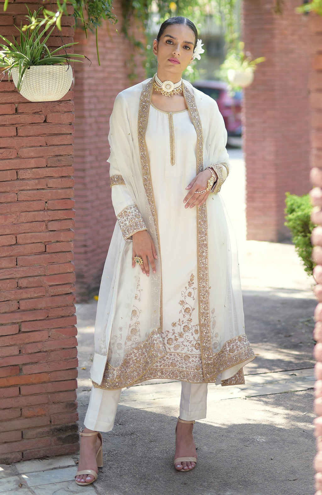 An elegant woman models an ivory-gold marori beads and sequin hand-embroidered kurta set.