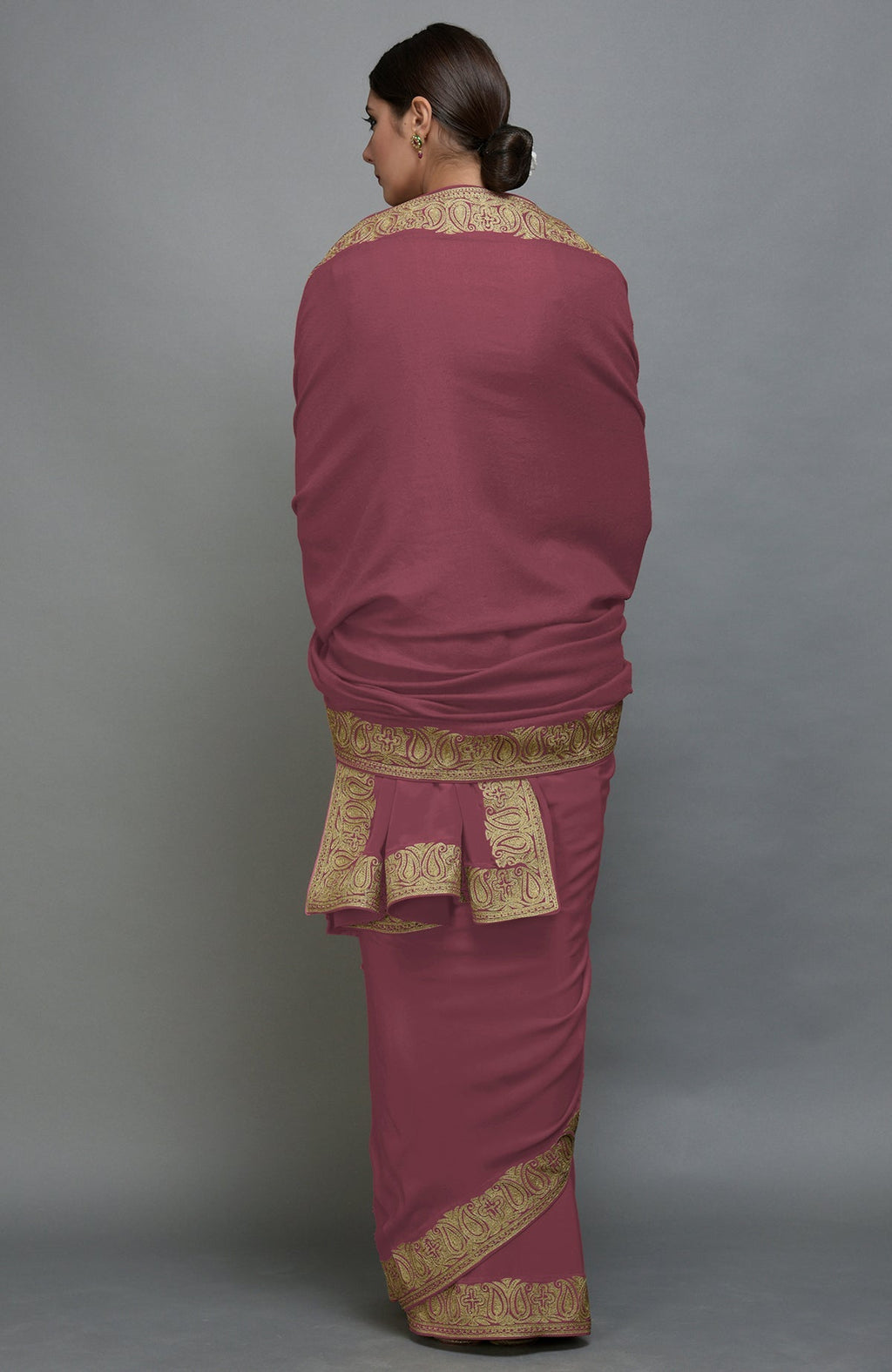 A woman from behind models a China Rose Kashmiri Tilla Aari Embroidered Saree and Pashmina Shawl Set.