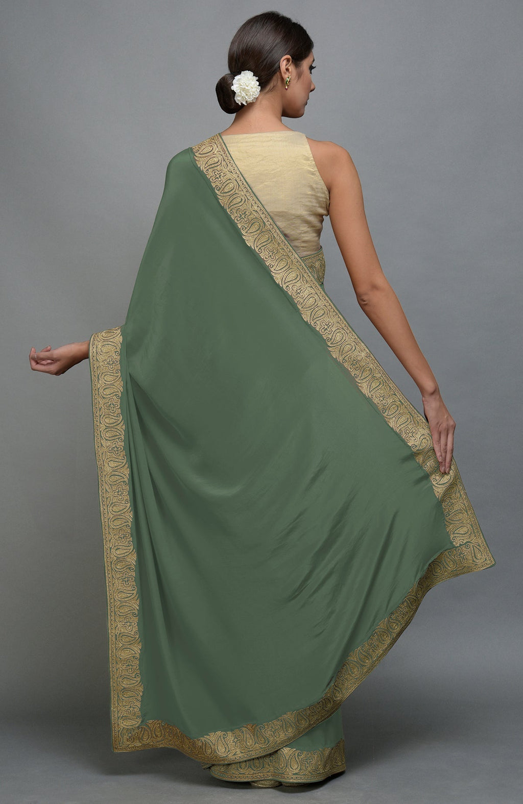 Dark jade saree with gold paisley embroidered borders.