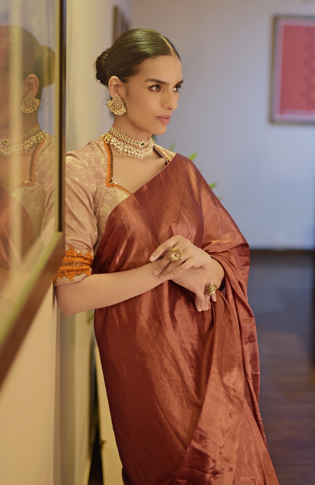 Pre-stitched copper tissue saree with a zardozi embroidered blouse.