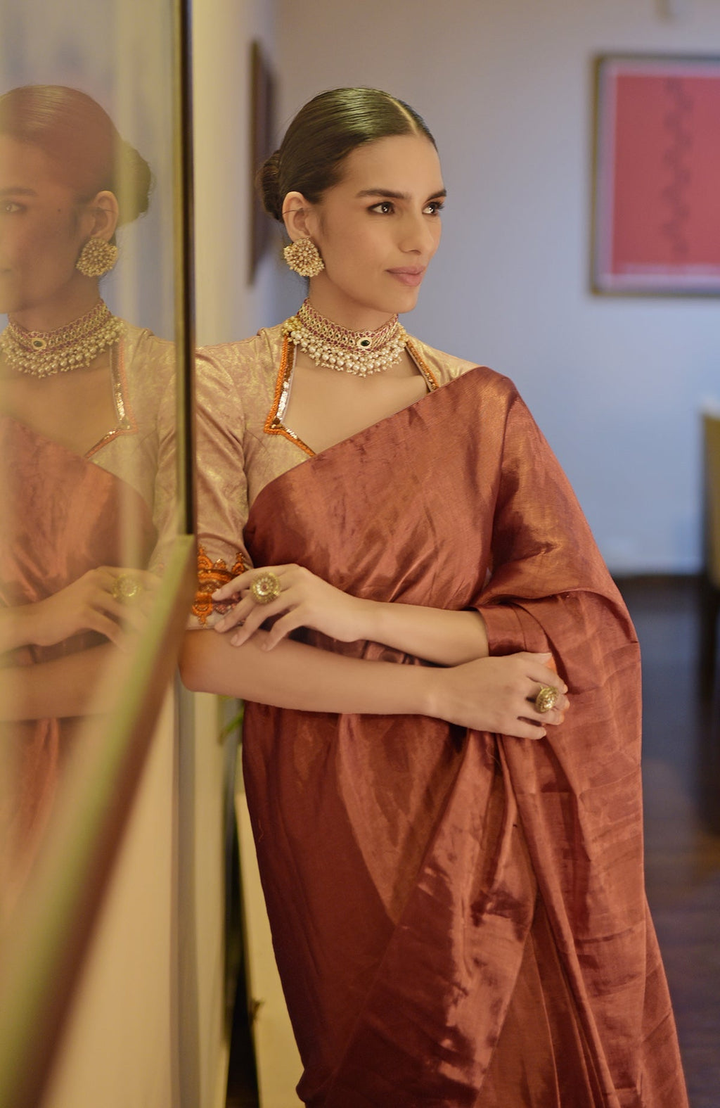 Pre-stitched copper tissue saree with a zardozi embroidered blouse.