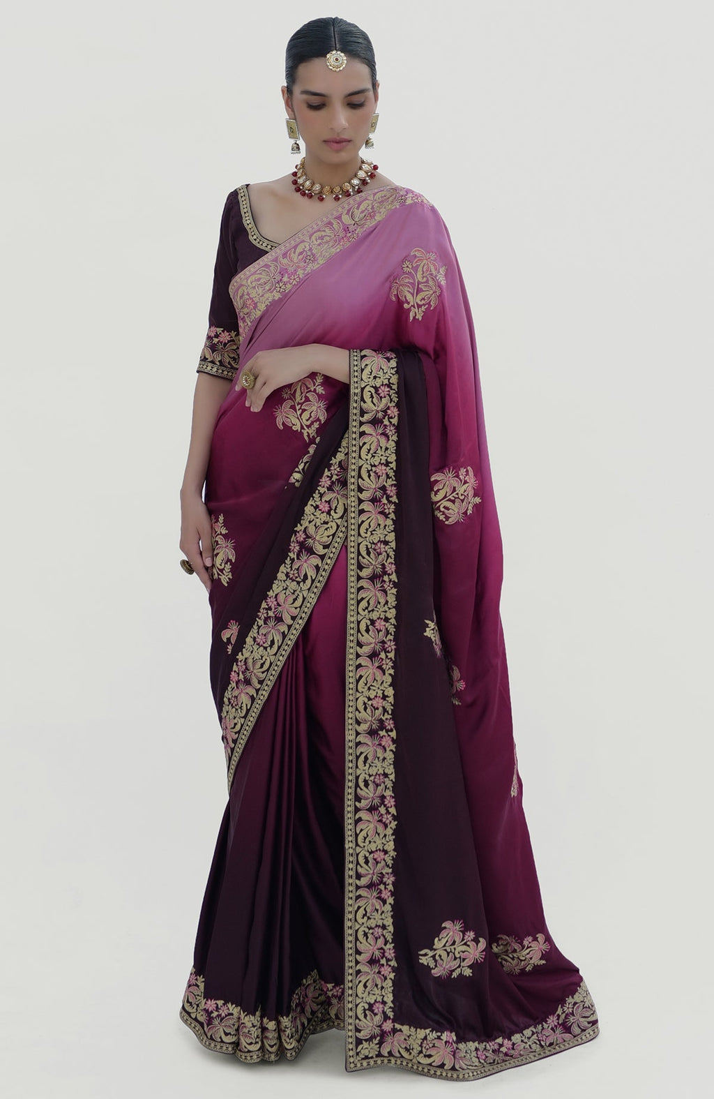A woman models a wine-pink ombre Kashidakari embroidered saree set.