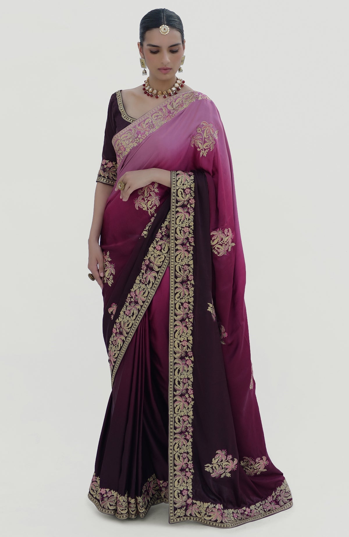 A woman models a wine-pink ombre Kashidakari embroidered saree set.