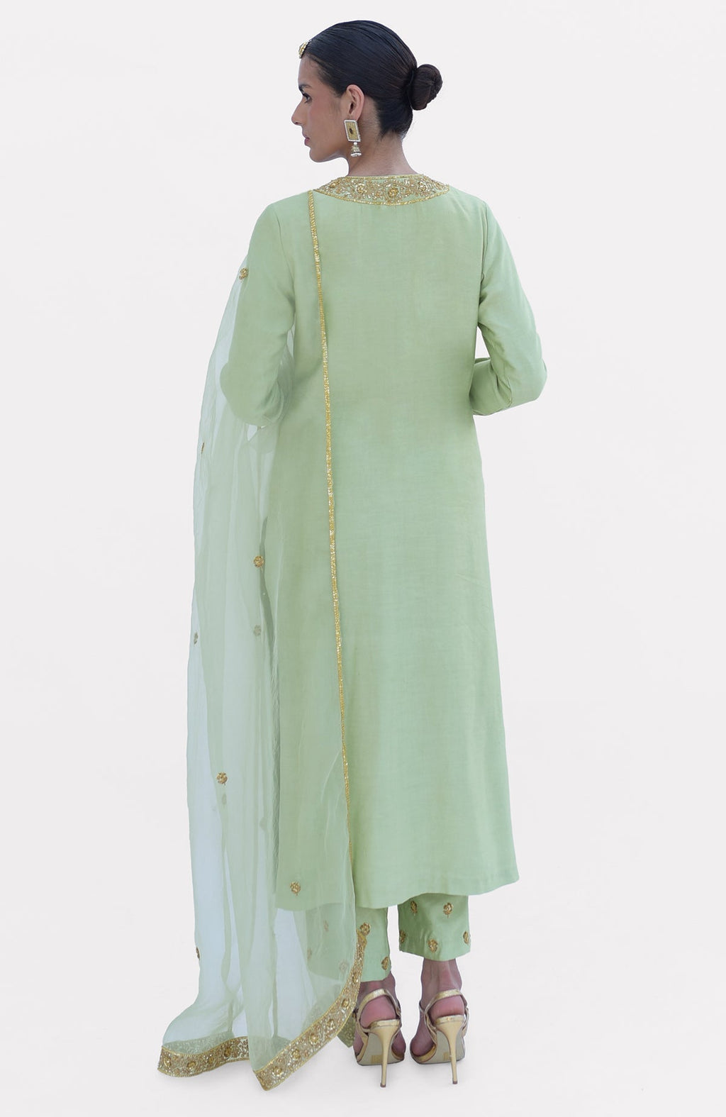 Pista green kurta set with gold embroidery, dupatta, and pants, worn by a model.