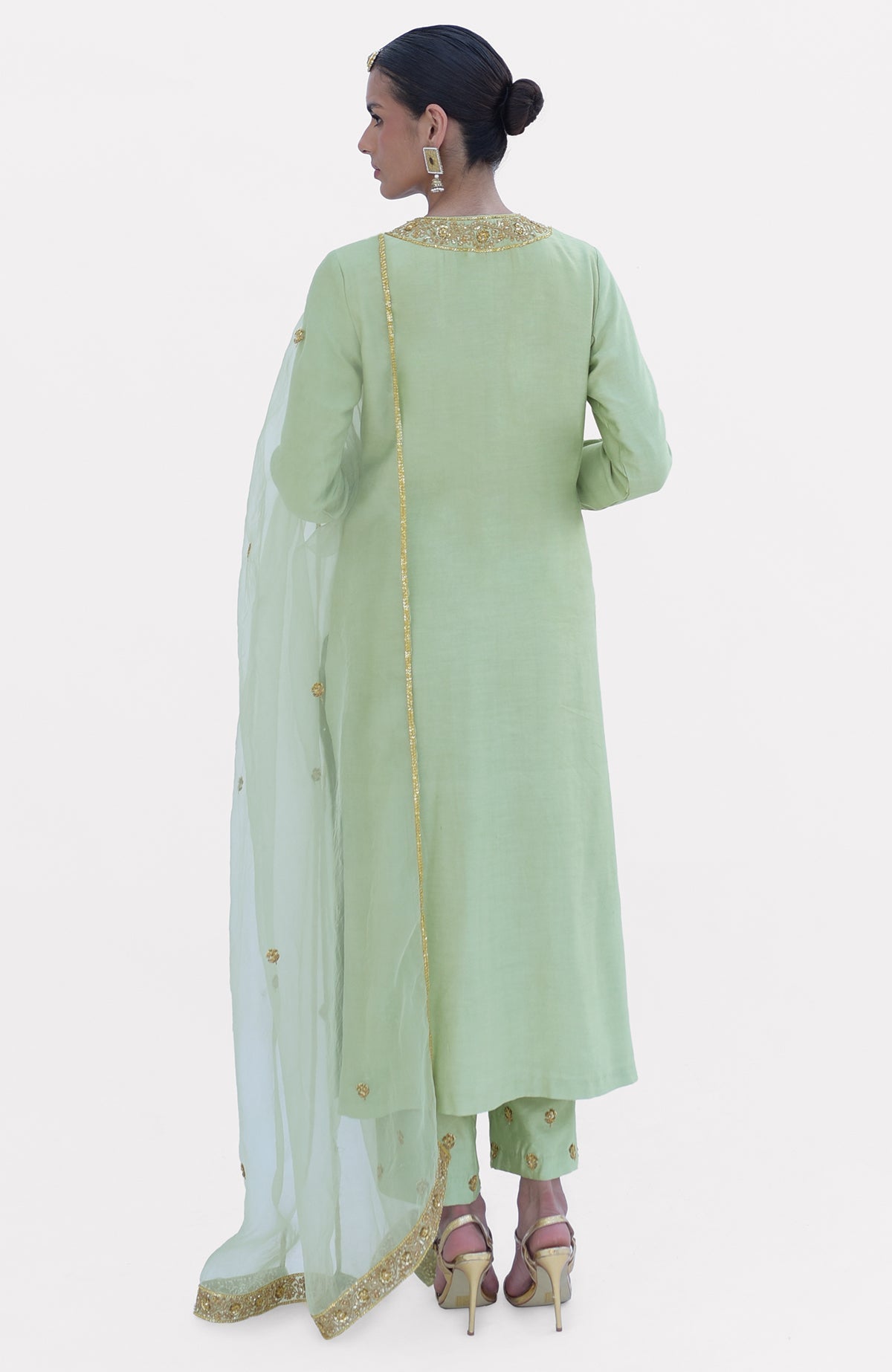 Pista green kurta set with gold embroidery, dupatta, and pants, worn by a model.