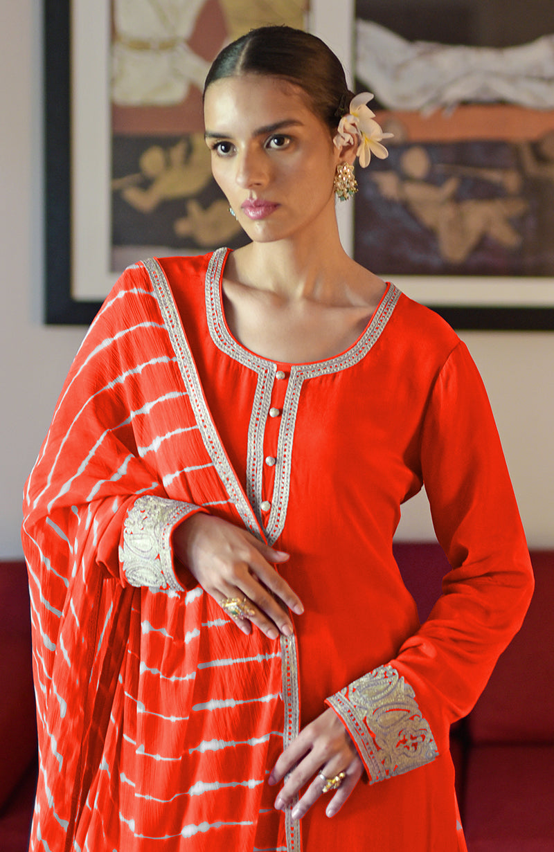 Tomato red leheriya sharara set with silver tilla embroidery.