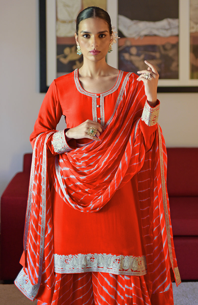 Tomato red leheriya sharara set with silver tilla embroidery.