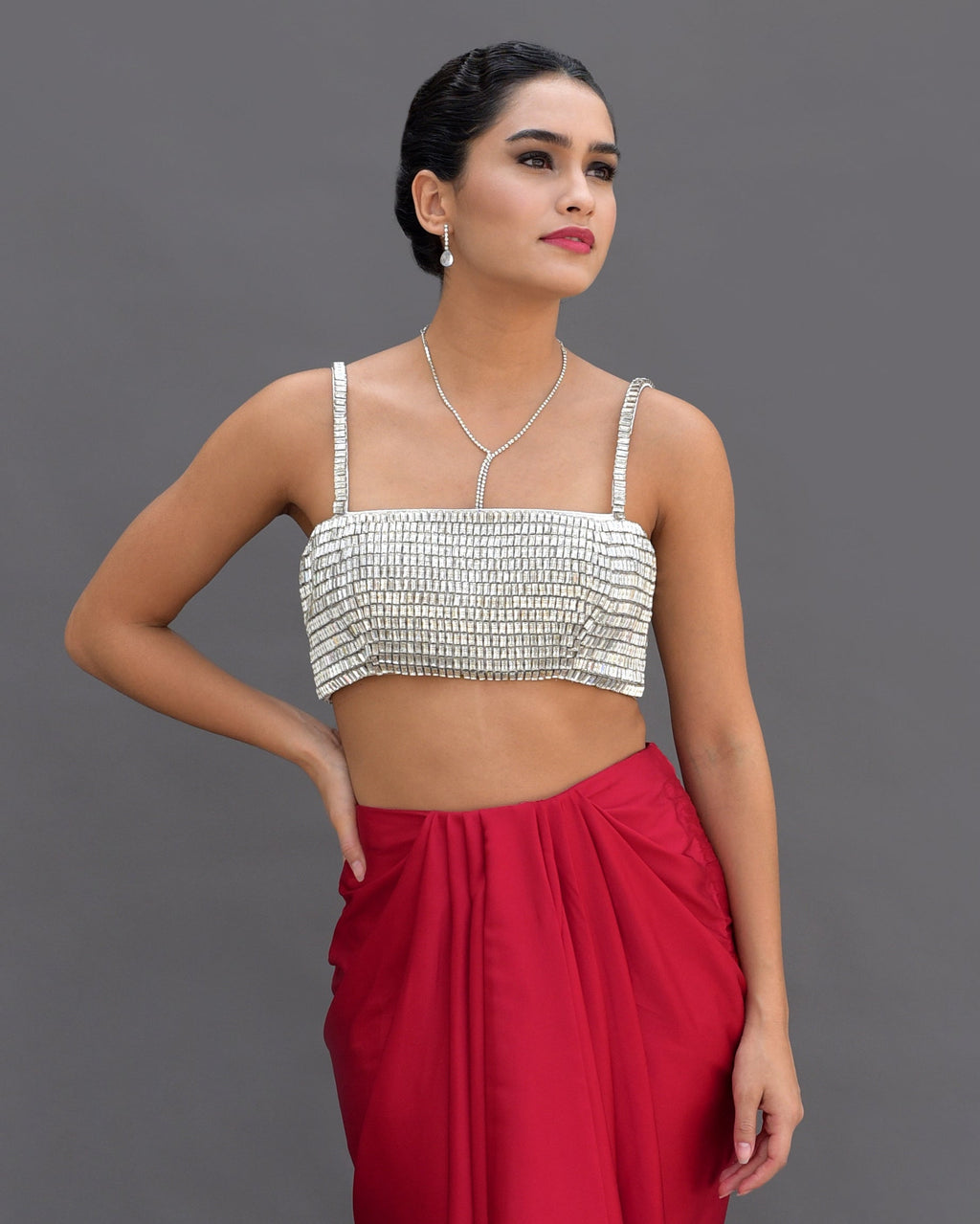 Diamante crystal hand-embroidered bustier with a red draped skirt.