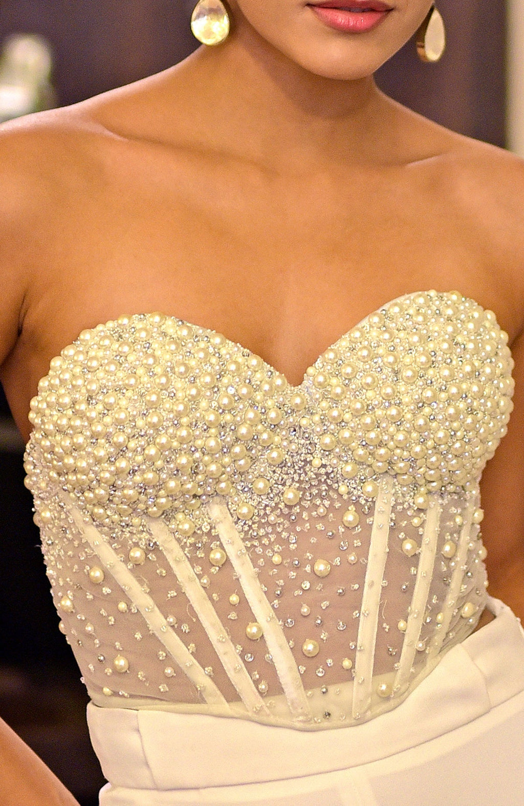 White hand-embroidered corset with pearls and silver embellishments.