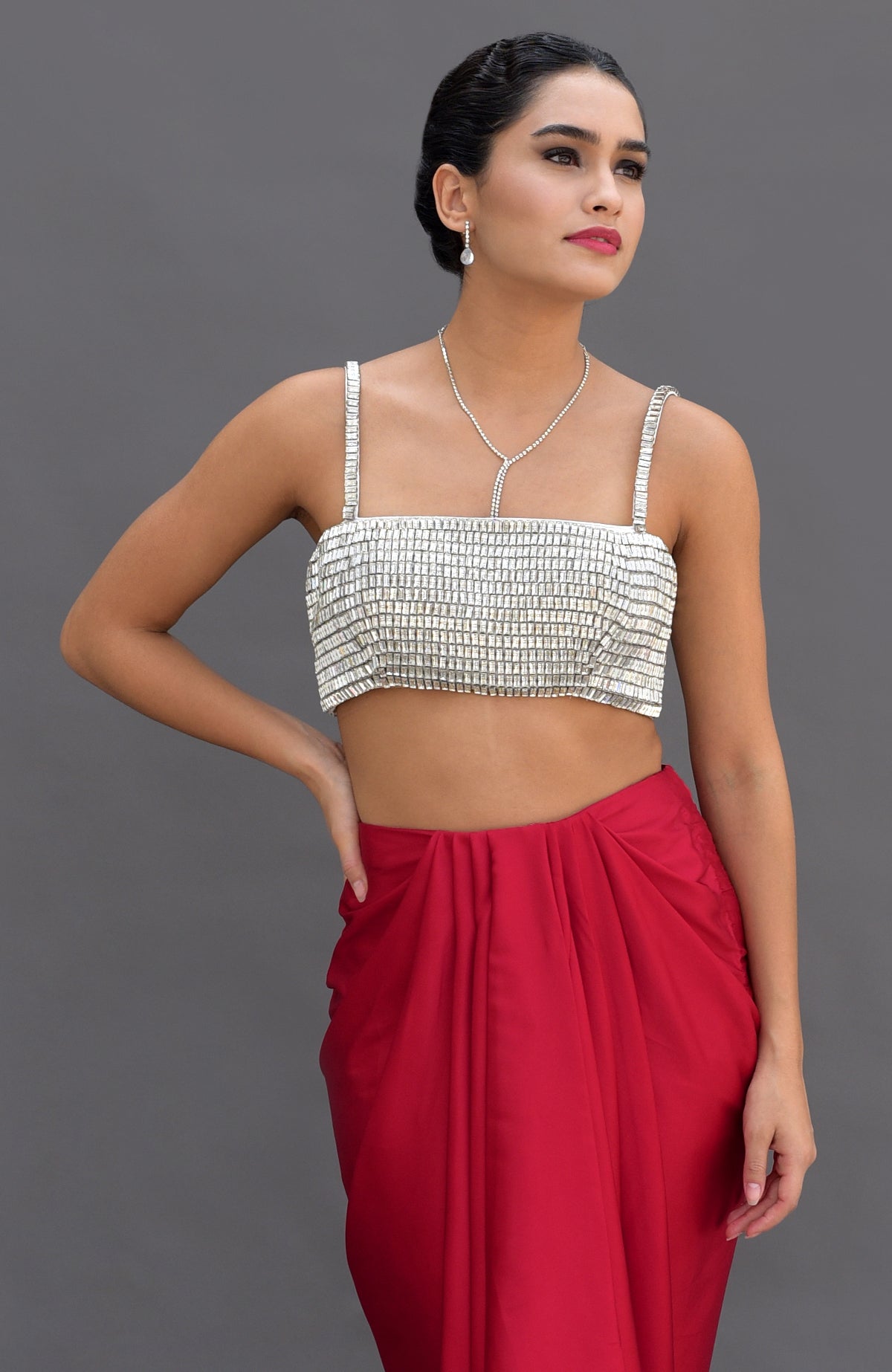 Diamante crystal embroidered bustier and red draped skirt set.