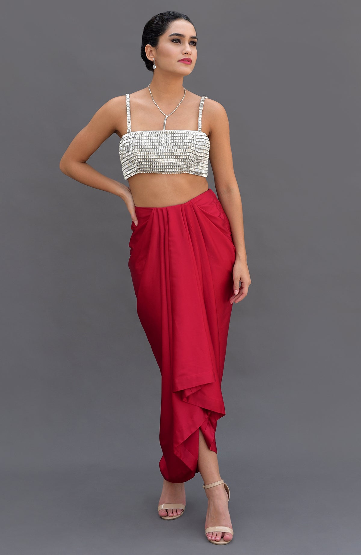 Diamante crystal hand-embroidered bustier and red draped skirt set.