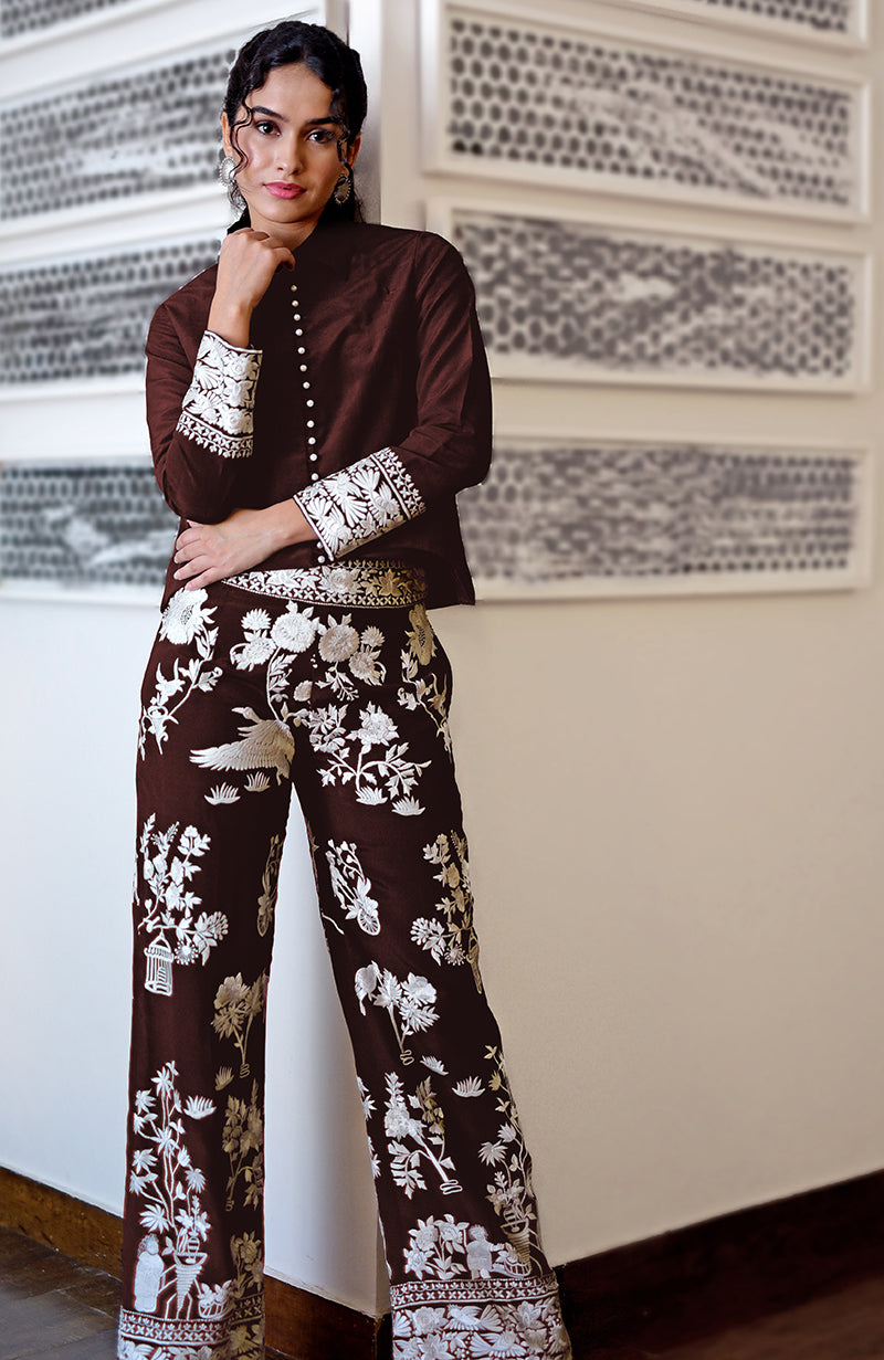 A woman models a Marsala Parsi Gara embroidered co-ord set with a short shirt and pants.