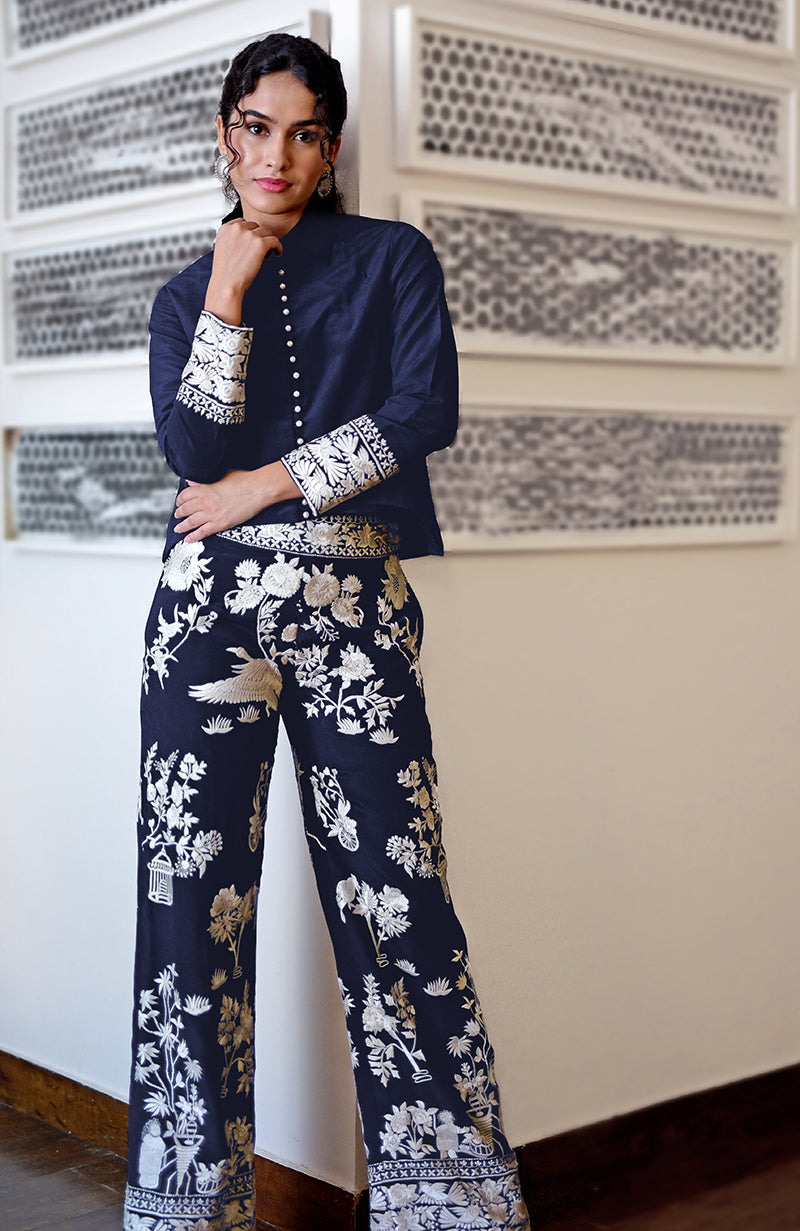 A woman models a navy blue Parsi Gara embroidered co-ord set.