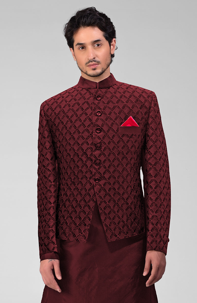 Maroon chikankari embellished bandhgala jacket set with a red pocket square.