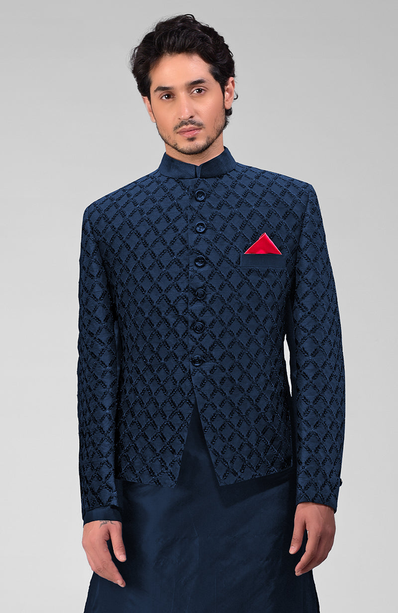 Navy blue chikankari embellished bandhgala jacket set with a red pocket square.