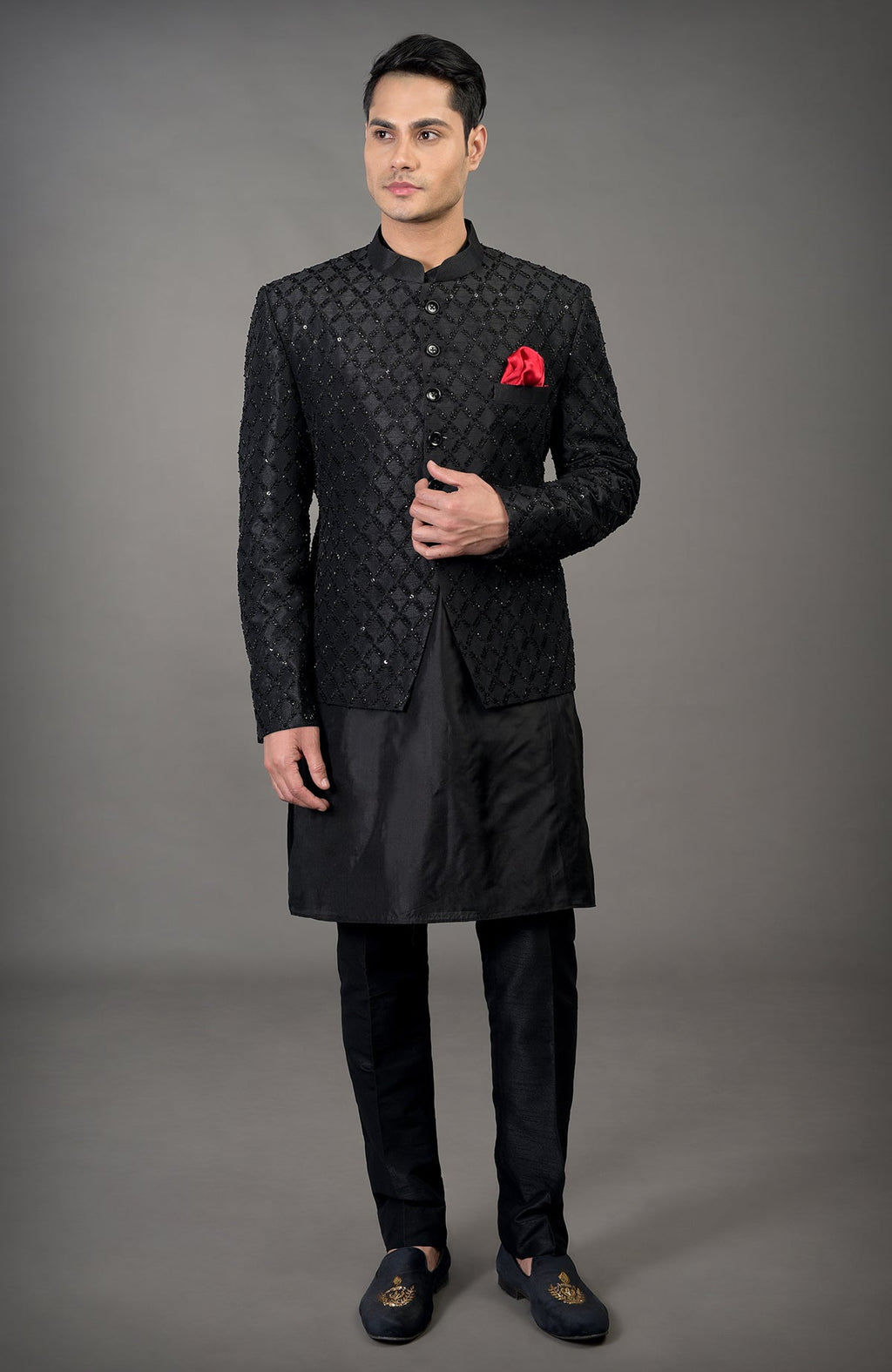 Black chikankari embellished bandhgala jacket set with a red pocket square.
