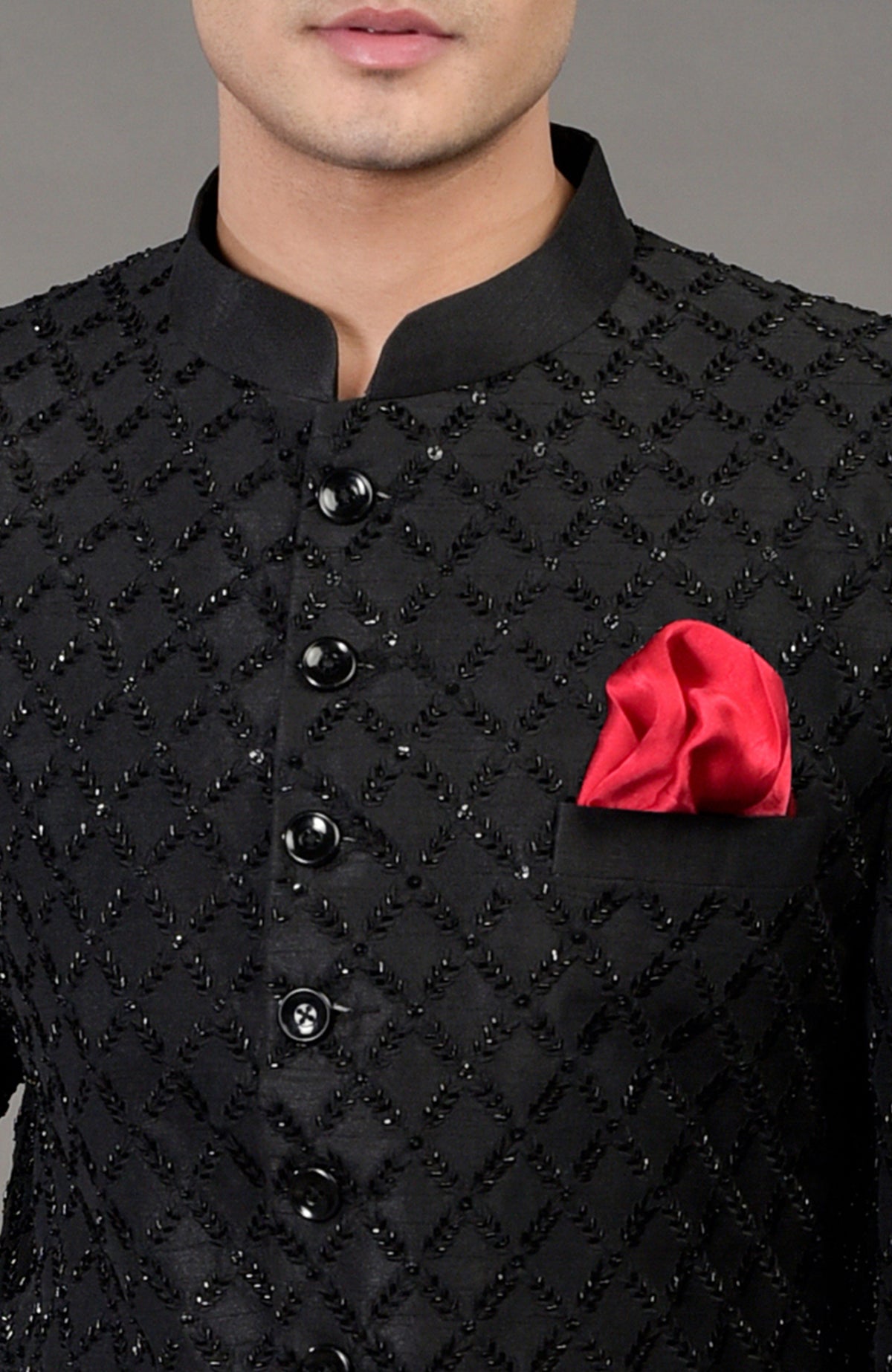 Black chikankari embellished bandhgala jacket with a red pocket square.