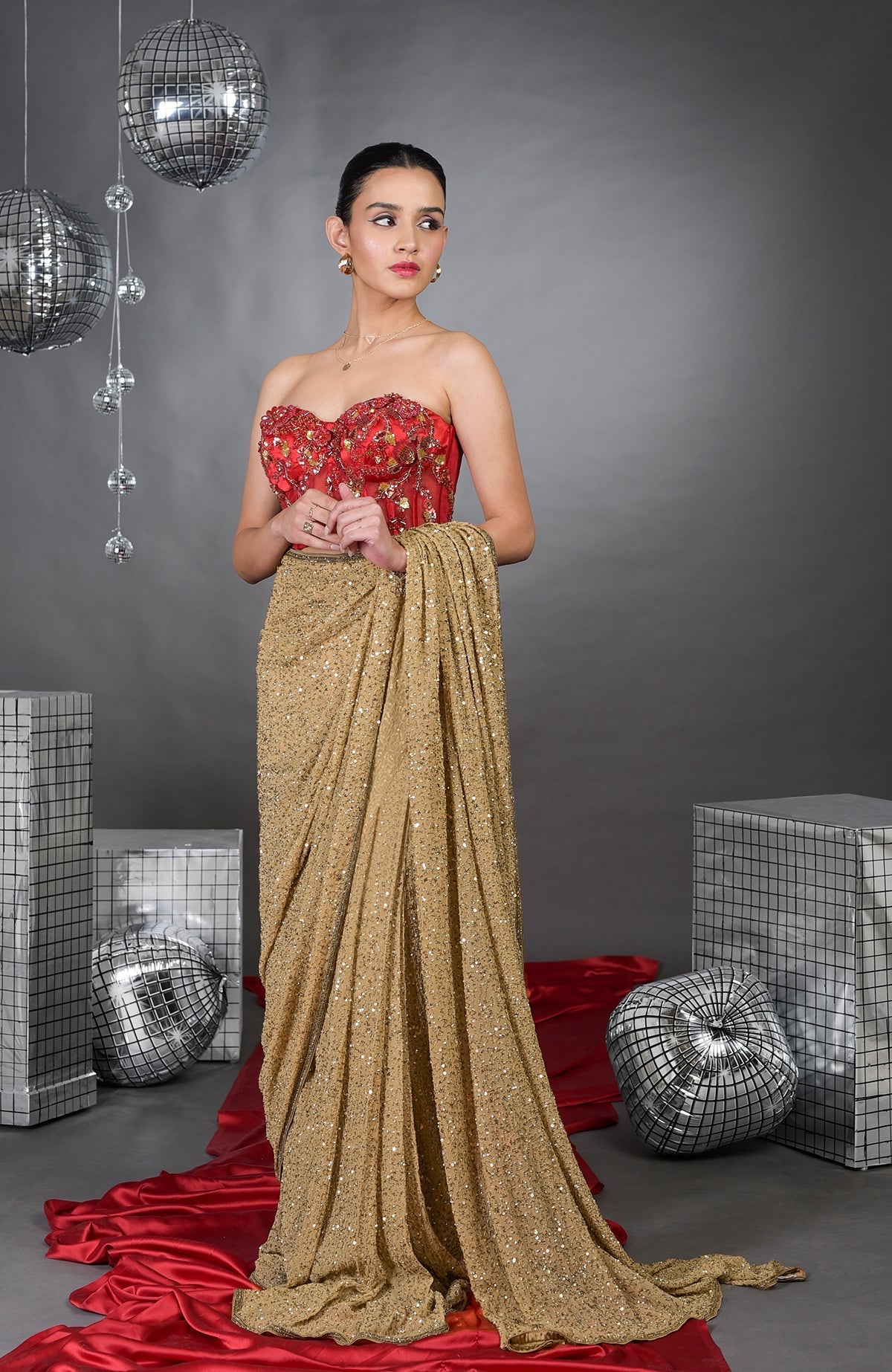 Madonna floral hand-embroidered corset with gold saree.