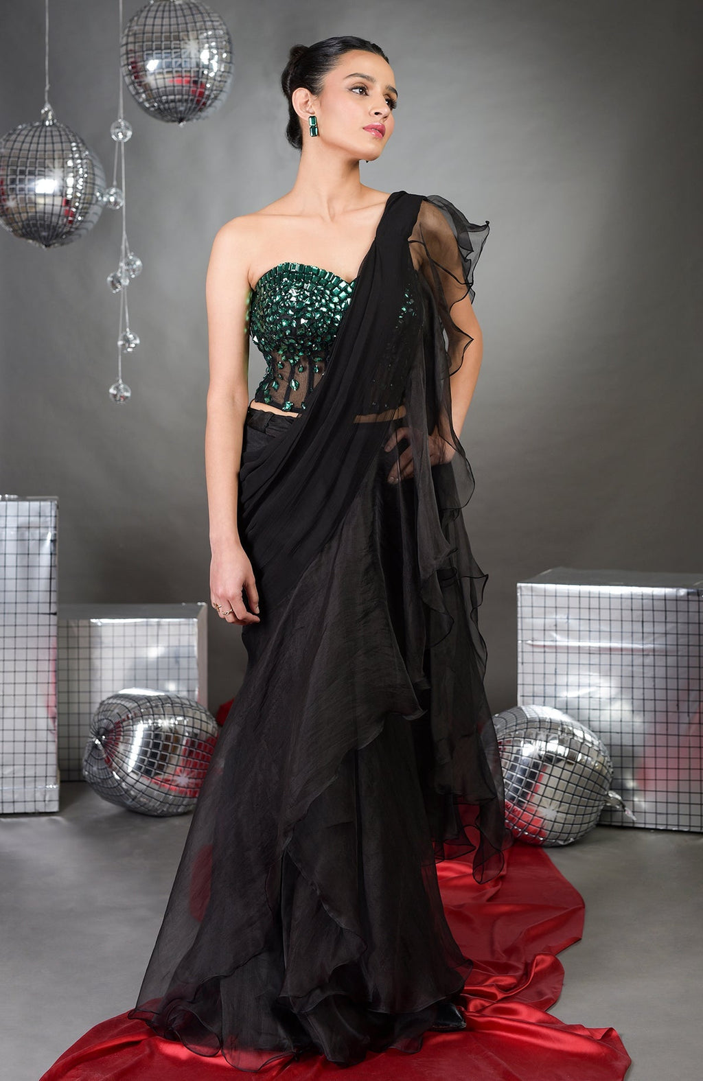 A woman models an Esmeralda hand-embroidered corset and ruffled saree set.