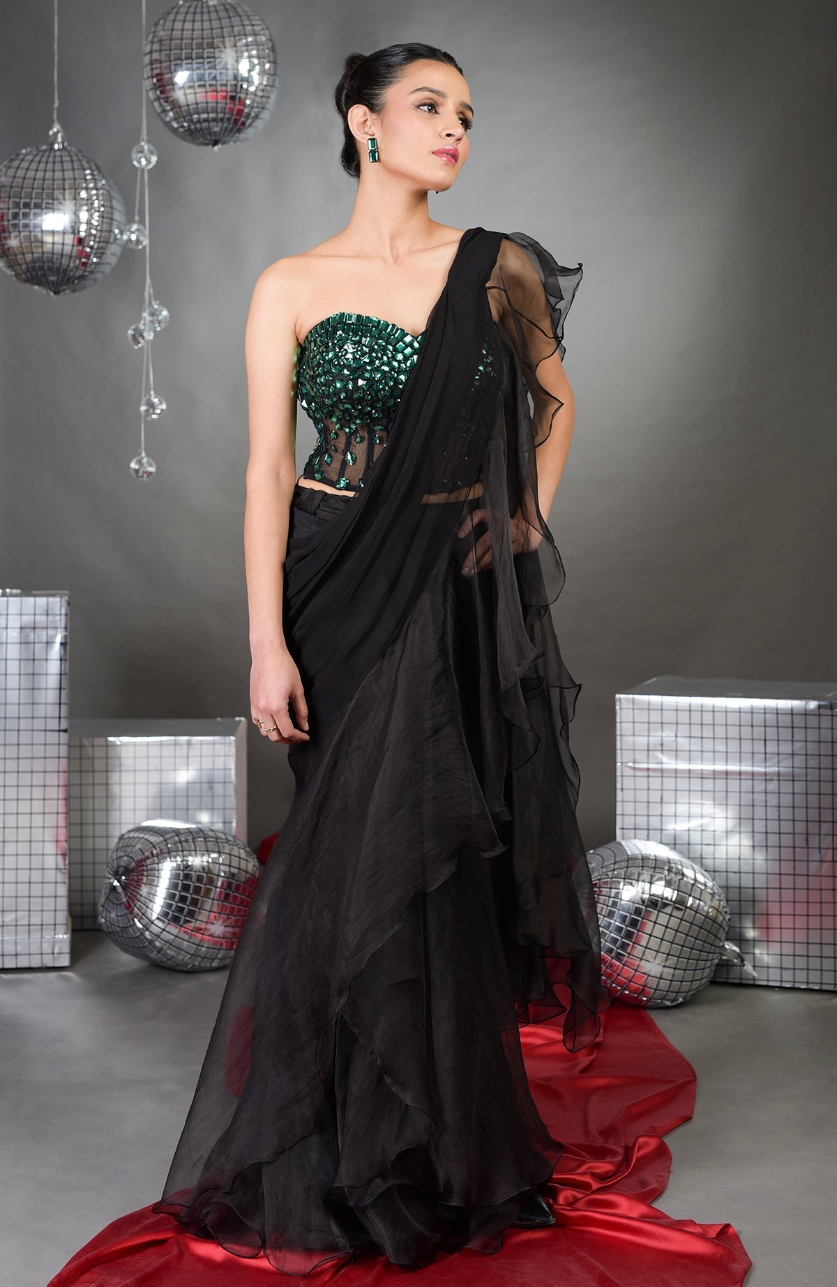 A woman models an Esmeralda hand-embroidered corset and ruffled saree set.