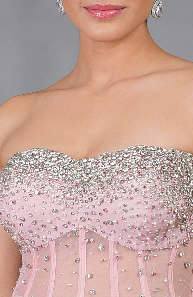 Close-up of a woman wearing a pink hand-embroidered corset with silver and pink crystals.