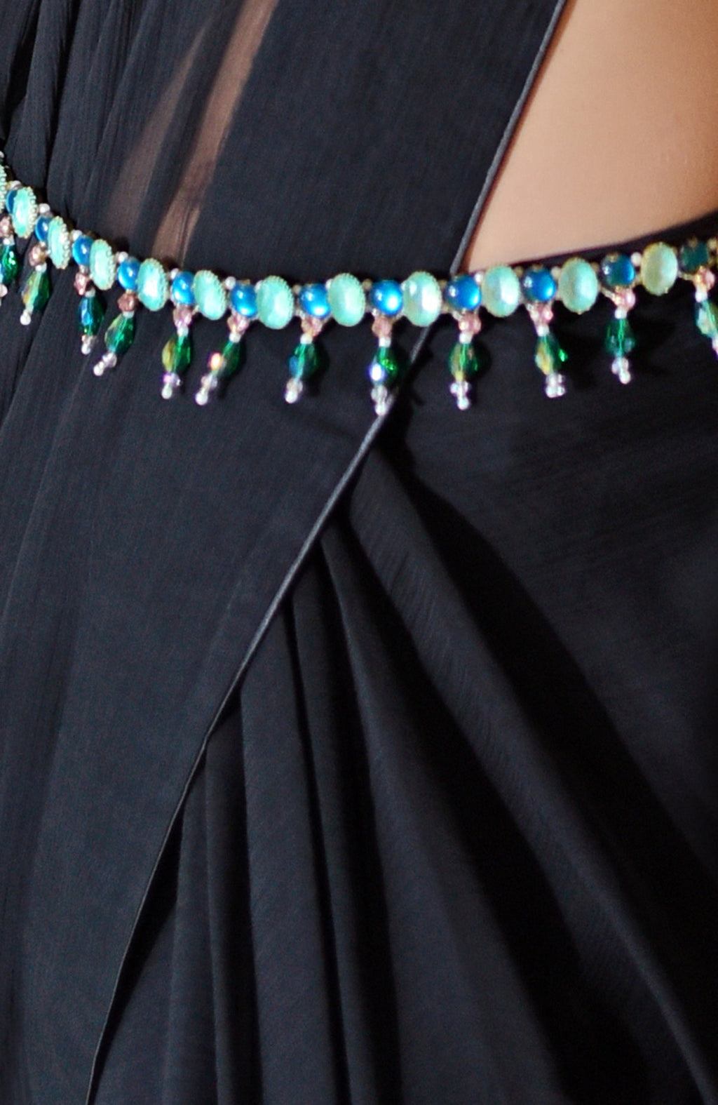 Black chiffon saree with a green and blue jeweled crystal belt.