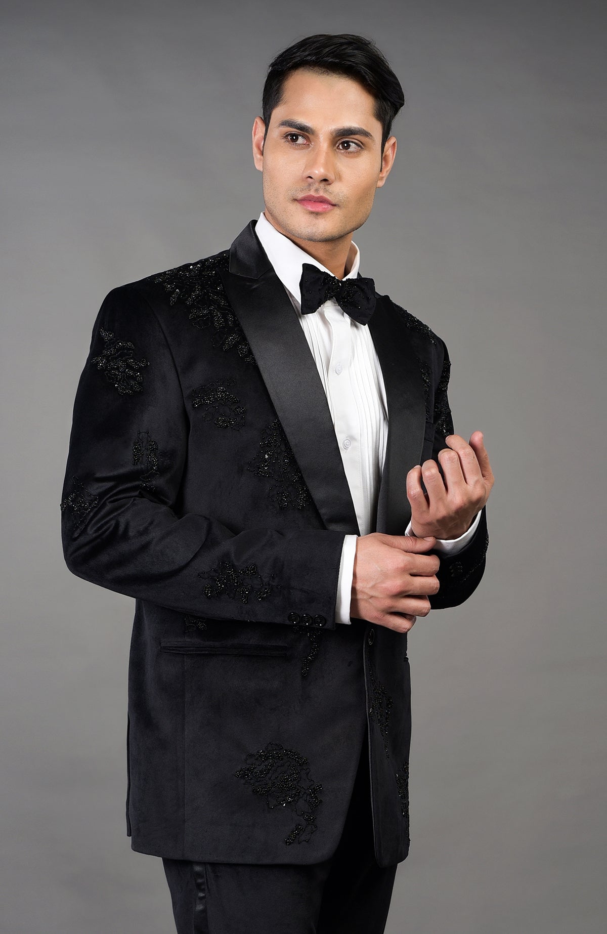 Black Italian velvet tuxedo set with intricate hand embroidery and a satin peak lapel.