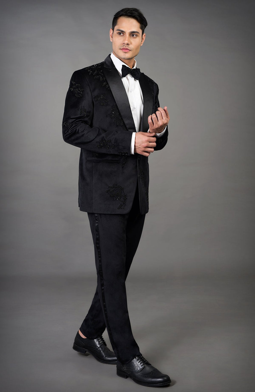 Black velvet tuxedo set with intricate embroidery and satin lapels.