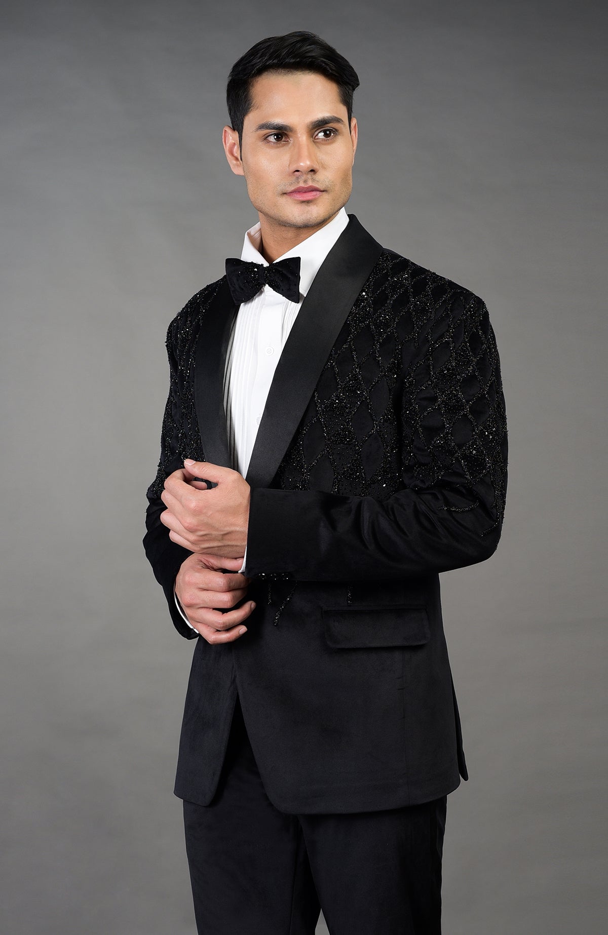 Black Italian velvet tuxedo with hand-embroidered geometric beading and satin lapels.