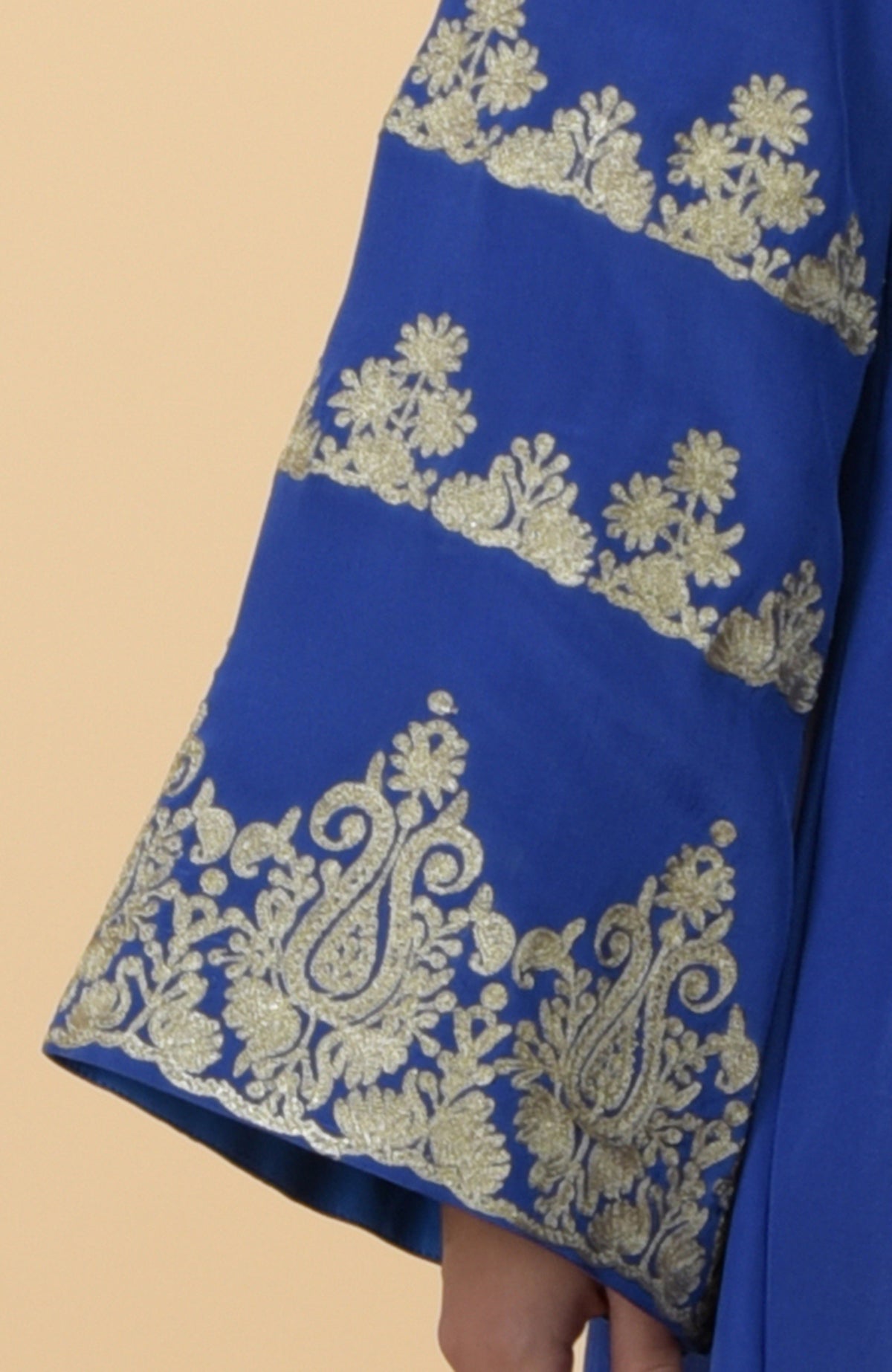 Cobalt blue kaftan sleeve with intricate gold Kashmir embroidery.