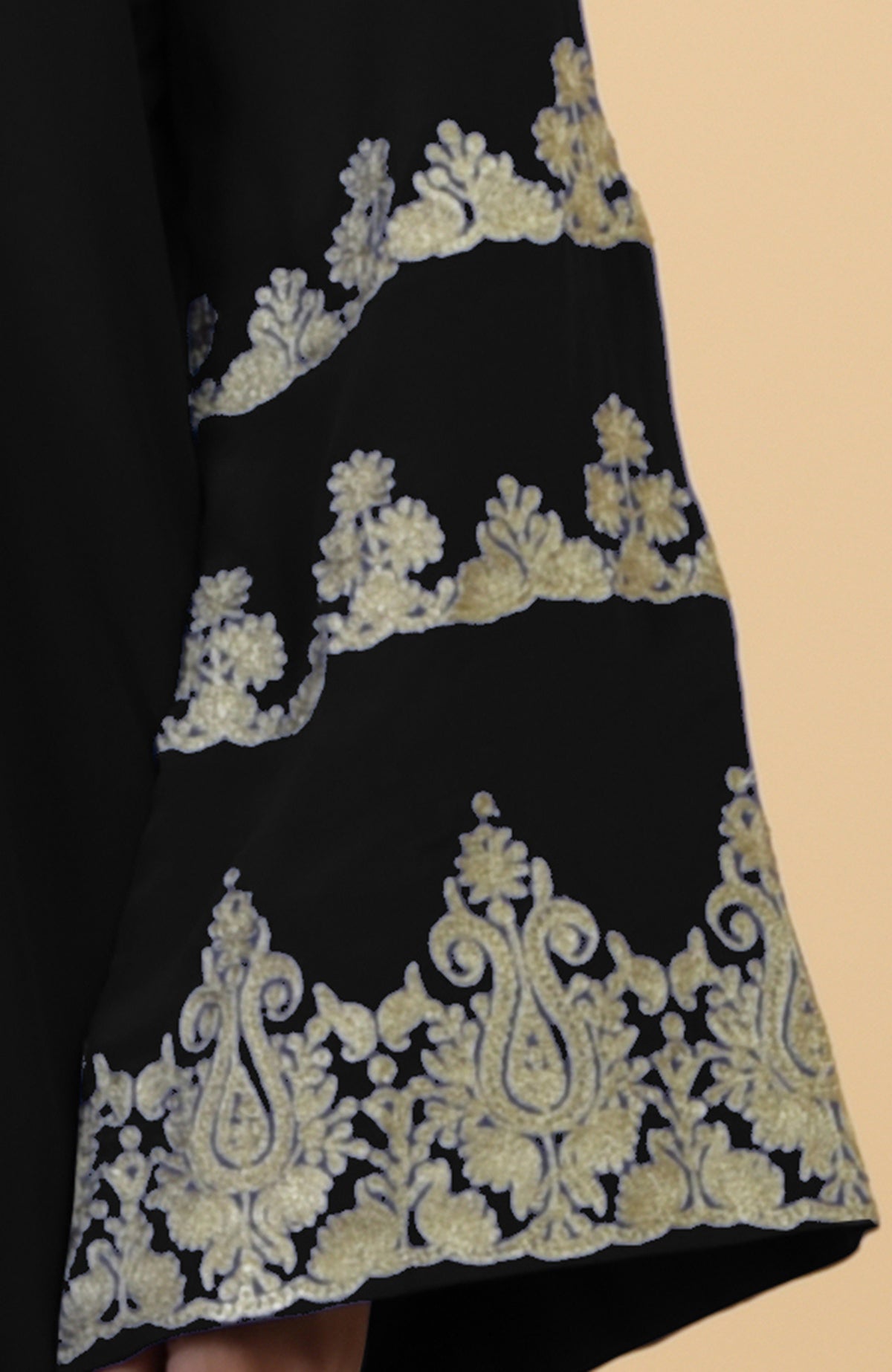 Black kaftan with gold Kashmir-inspired embroidery on the bell-shaped sleeves.