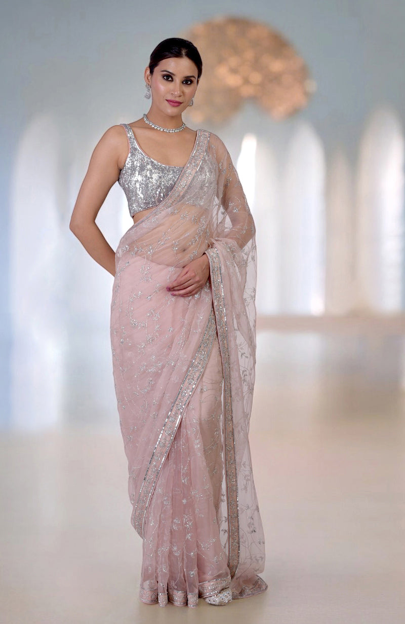 An oyster pink saree with silver beads and sequin zardozi hand embroidery.