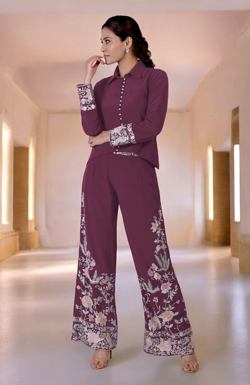 A woman models a maroon Parsi Gara embroidered co-ord set with floral patterns.
