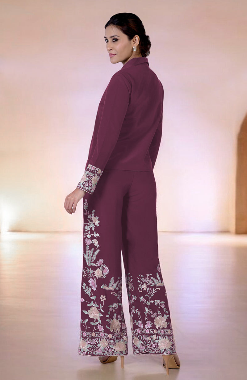 A woman models a maroon Parsi Gara embroidered co-ord set with floral patterns.