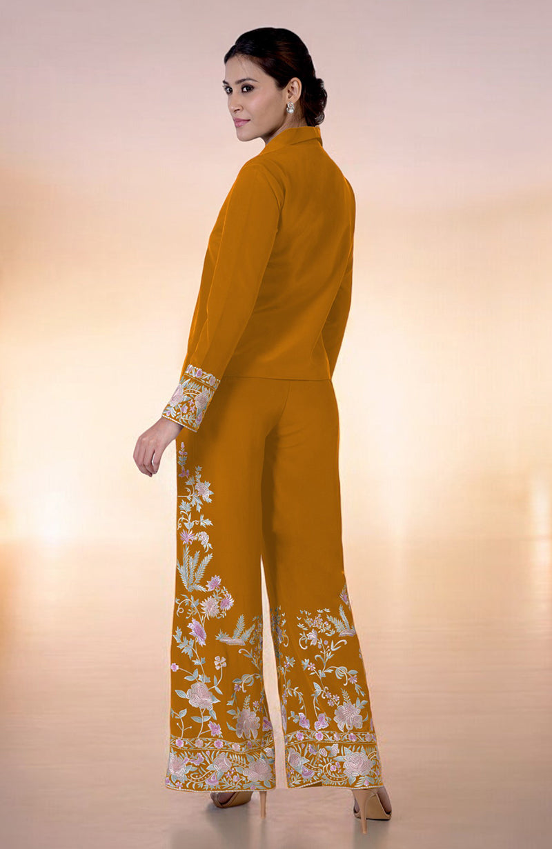 A woman models a yam Parsi Gara embroidered co-ord set with a high-low top.